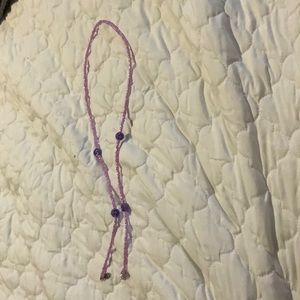 i am selling a purple smiley necklace.